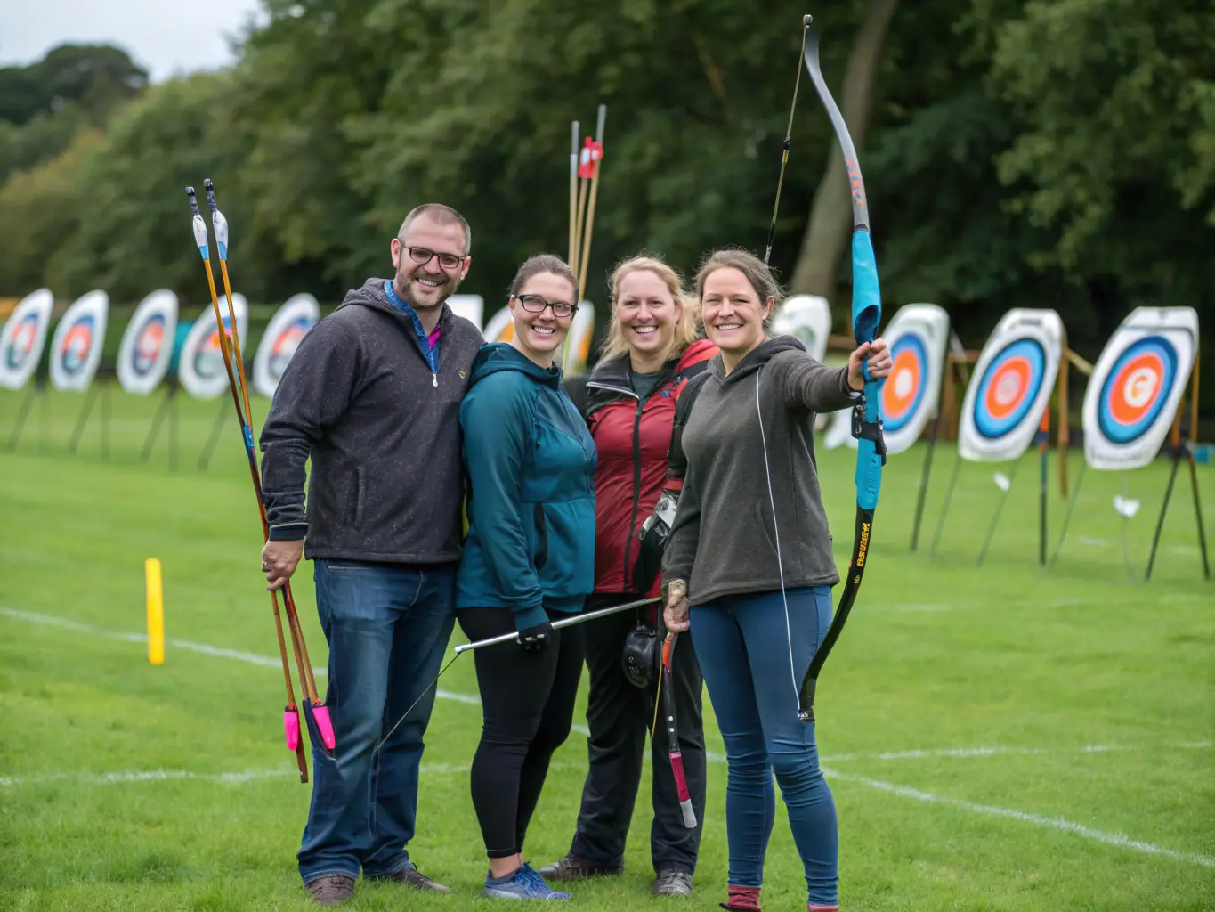 A group of archers of varying ages and skill levels laughing and sharing tips on the archery range, emphasizing the social aspect of the club.